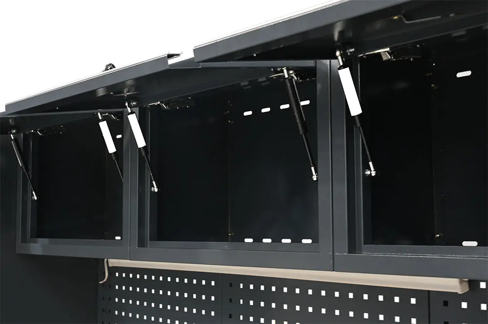 Overhead cabinet doors open above the garage worktop and pegboards